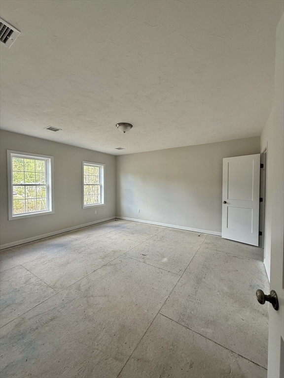 1 A Dudley Road Townsend, MA 01469 - Photo 10 of 17 an empty room with windows and closet