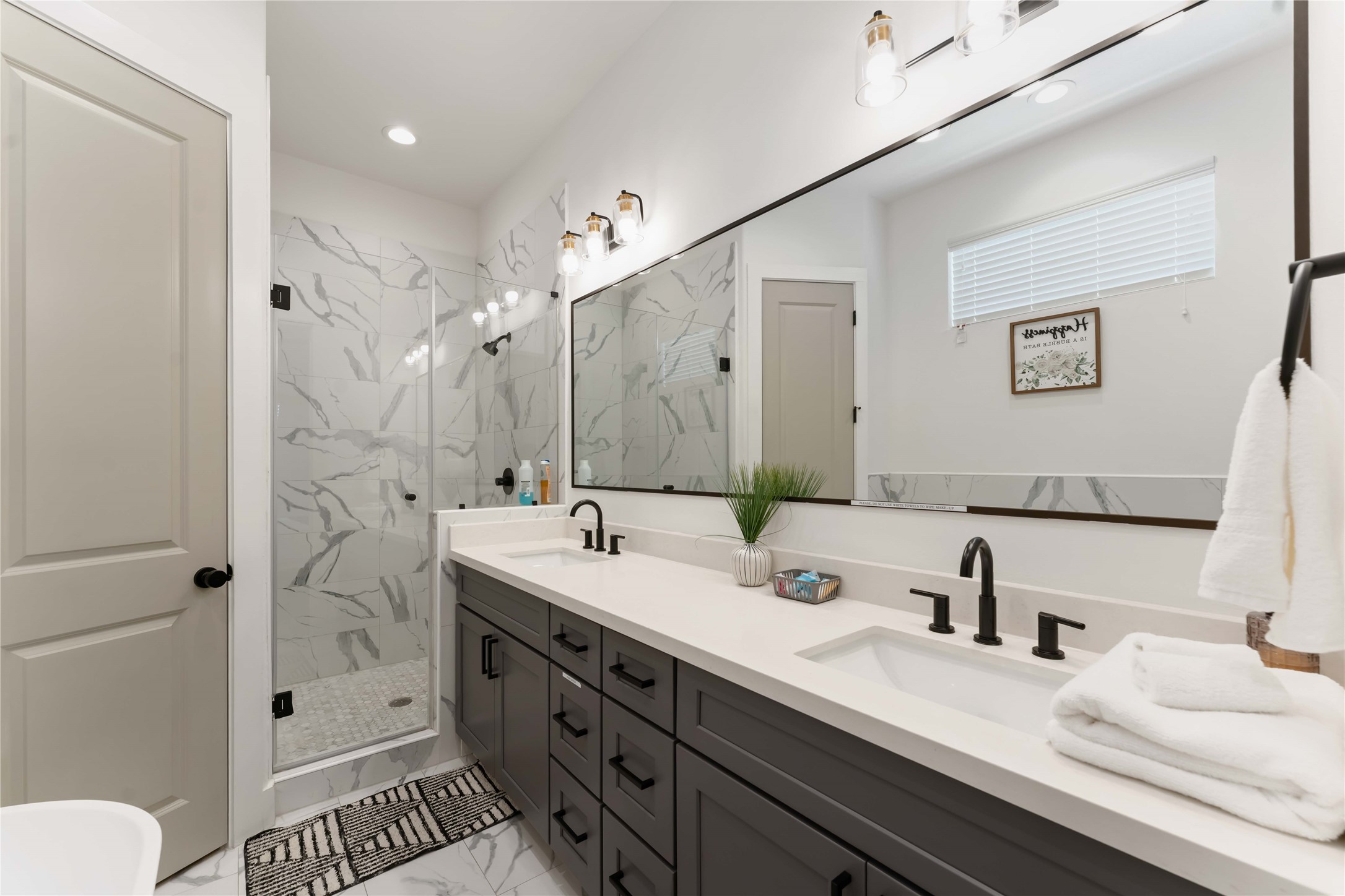2341 Eagle Street Houston, TX 77004 - Photo 21 of 30 a bathroom with a double vanity sink mirror double and shower