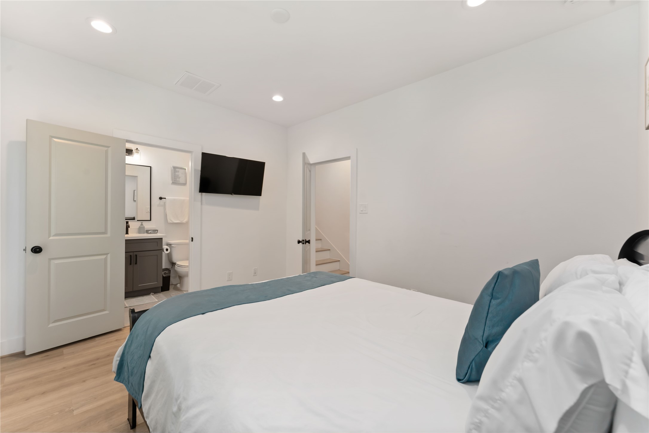 2341 Eagle Street Houston, TX 77004 - Photo 5 of 30 a bedroom with a bed and a flat tv screen on dresser