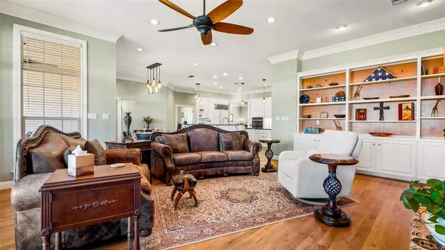 a living room with furniture a fireplace and a large window