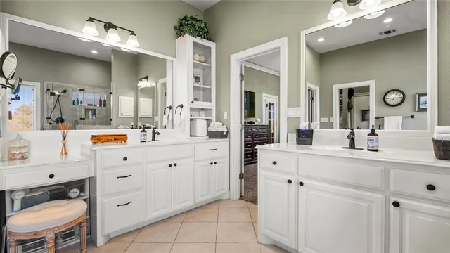 a bathroom with a tub a sink and a large mirror