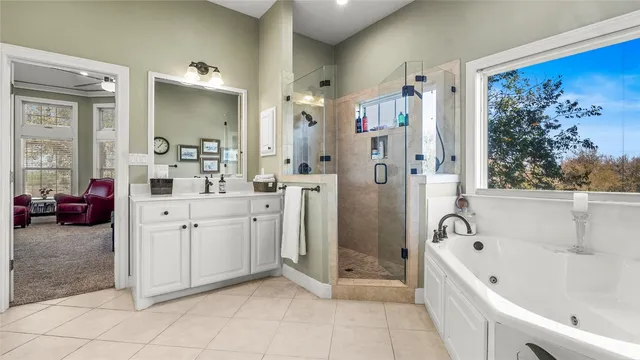 a bathroom with a sink vanity mirror and tub