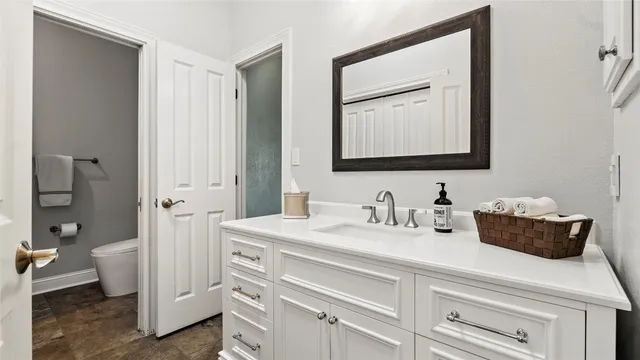 a bathroom with a sink toilet and a mirror