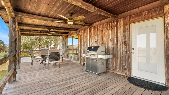 a view of a dining room with wooden floor and furniture