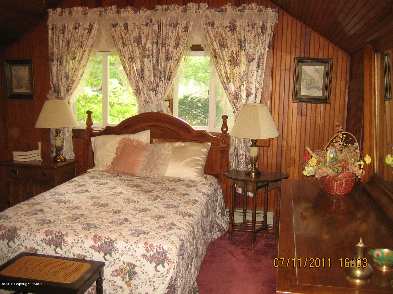 Henry Price Road Cresco, PA 18326 - Photo 29 of 36 a bedroom with a bed and a chandelier