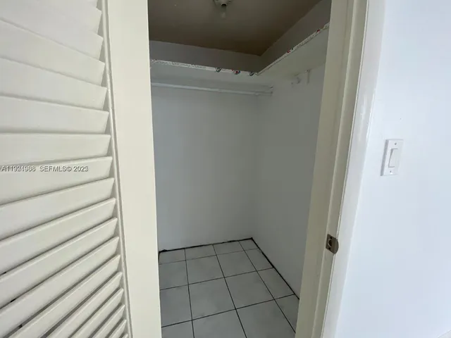a bathroom with a shower sink mirror and toilet
