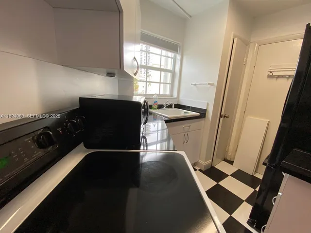 a living room with a black white checkered floor with a fireplace
