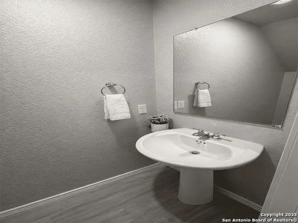 a bathroom with a sink a mirror and a toilet