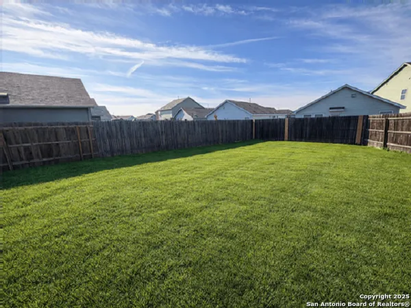 a view of a backyard of the house