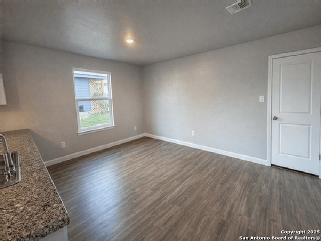431 Ambush Ridge San Antonio, TX 78220 - Photo 4 of 17 an empty room with wooden floor and windows