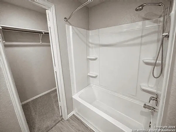 a bathroom with a shower and a bath tub