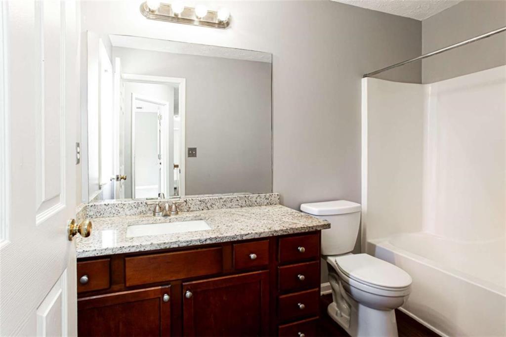 3721 Bogan Mill Road Northeast Buford, GA 30519 - Photo 34 of 58 a bathroom with a granite countertop sink toilet and mirror