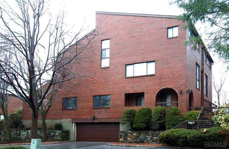 150 North Bedford Road, Unit 2A Chappaqua, NY 10514 - Photo 1 of 1 a front view of a building with a garden