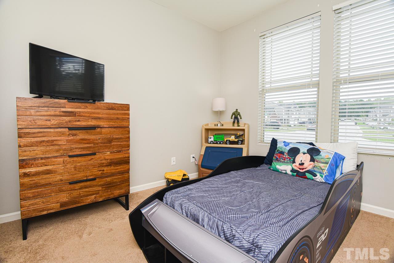 3644 Tule Spring Street Raleigh, NC 27610 - Photo 11 of 18 a bed room with a bed and a television