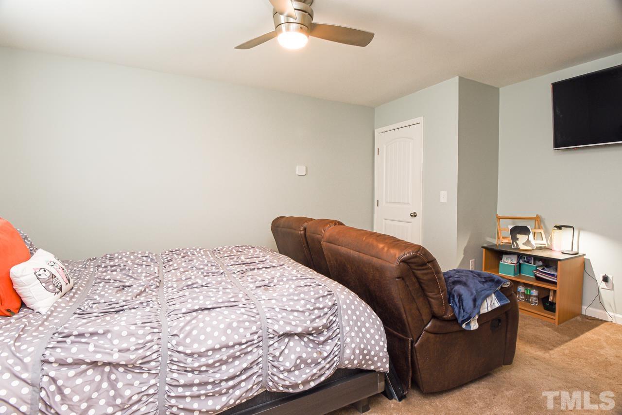 3644 Tule Spring Street Raleigh, NC 27610 - Photo 13 of 18 a bedroom with a bed and a flat screen tv