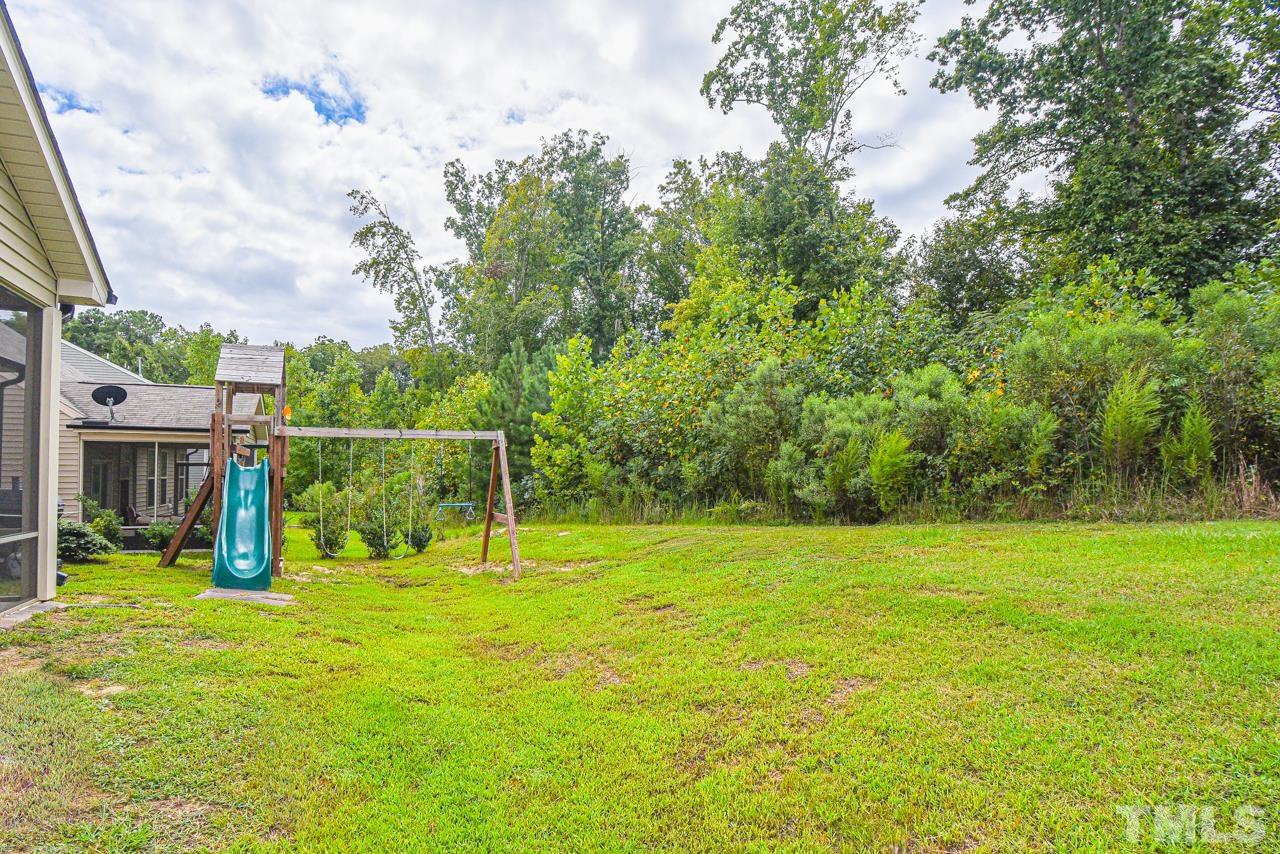 3644 Tule Spring Street Raleigh, NC 27610 - Photo 18 of 18 a view of a garden with a slide