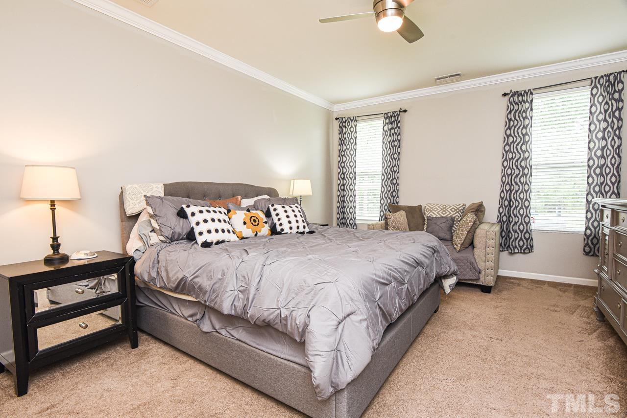 3644 Tule Spring Street Raleigh, NC 27610 - Photo 6 of 18 a bedroom with a bed and a night stand