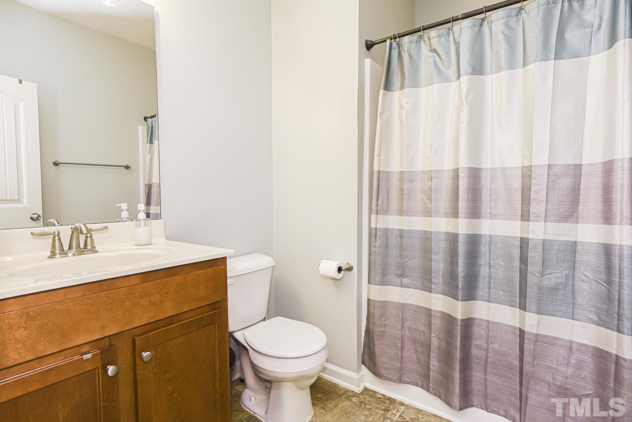 3644 Tule Spring Street Raleigh, NC 27610 - Photo 10 of 18 a bathroom with a sink a toilet and shower