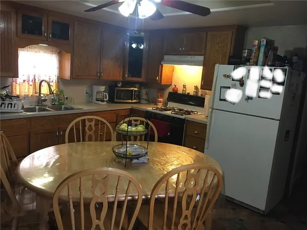 a kitchen with a table chairs and refrigerator