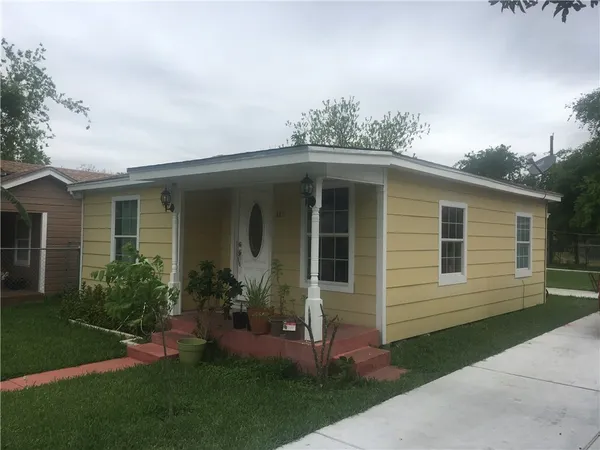 a front view of a house with a garden