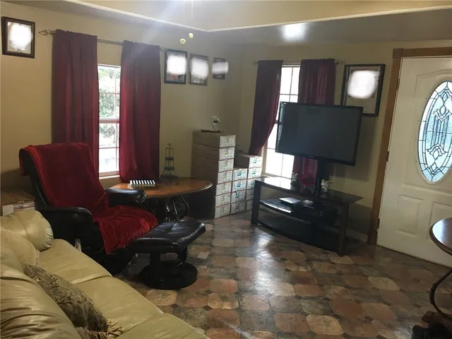 a living room with furniture and a toilet