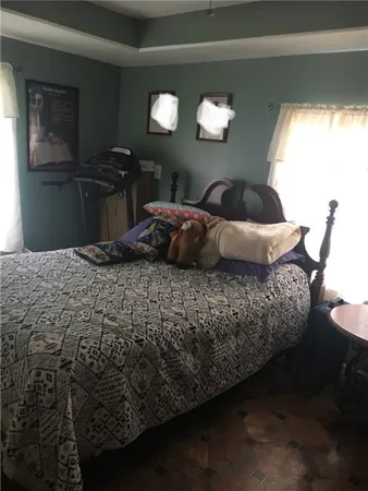 a bedroom with a bed and dresser with mirror
