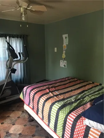 a bed sitting in a bedroom next to a window