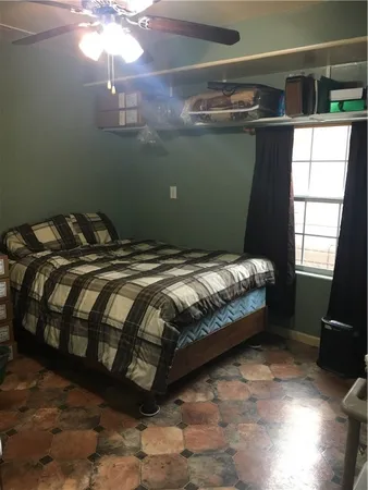 a bed sitting in a bedroom next to a window