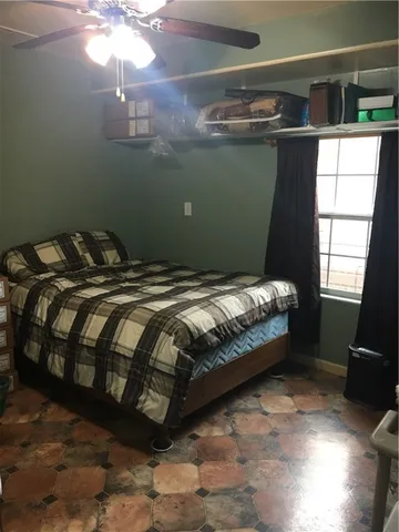 a bed sitting in a bedroom next to a window