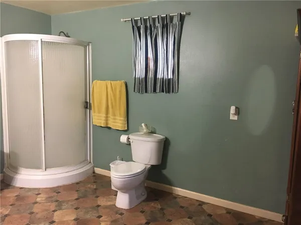 a white toilet sitting next to a bathroom sink