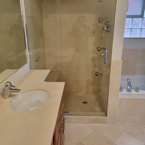a bathroom with a sink and shower