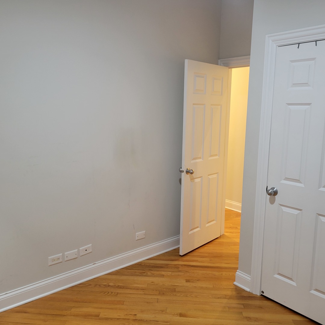 2022 North Wood Street, Unit 3S Chicago, IL 60614 - Photo 16 of 20 a view of an empty room with wooden floor and a window