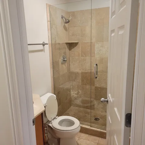 a bathroom with a toilet and a shower