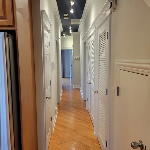 a view of a hallway with a wooden door