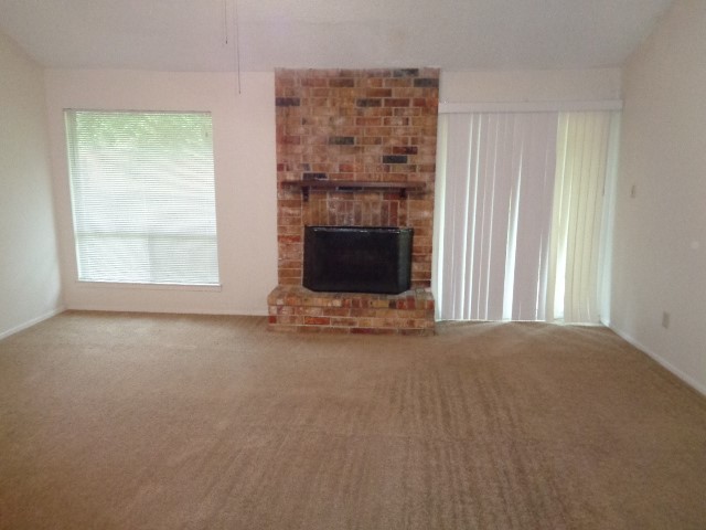 9530 Magnolia Ridge Drive Houston, TX 77070 - Photo 16 of 20 an empty room with a fireplace