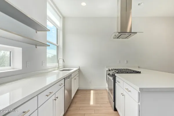a utility room with cabinets washer and dryer