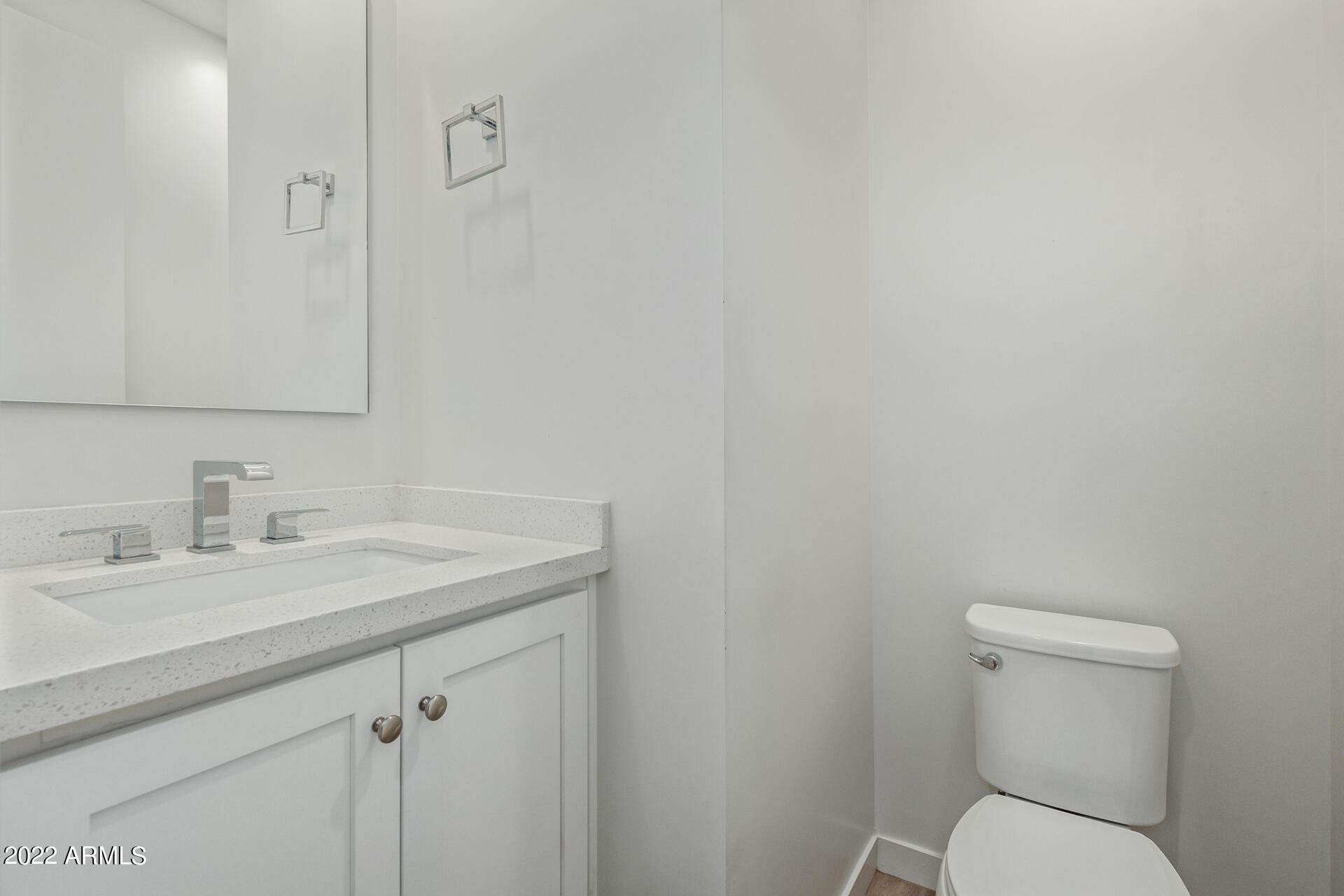 325 East Coronado Road, Unit 16 Phoenix, AZ 85004 - Photo 18 of 36 a bathroom with a toilet sink and mirror