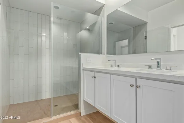 a bathroom with a shower sink vanity and mirror