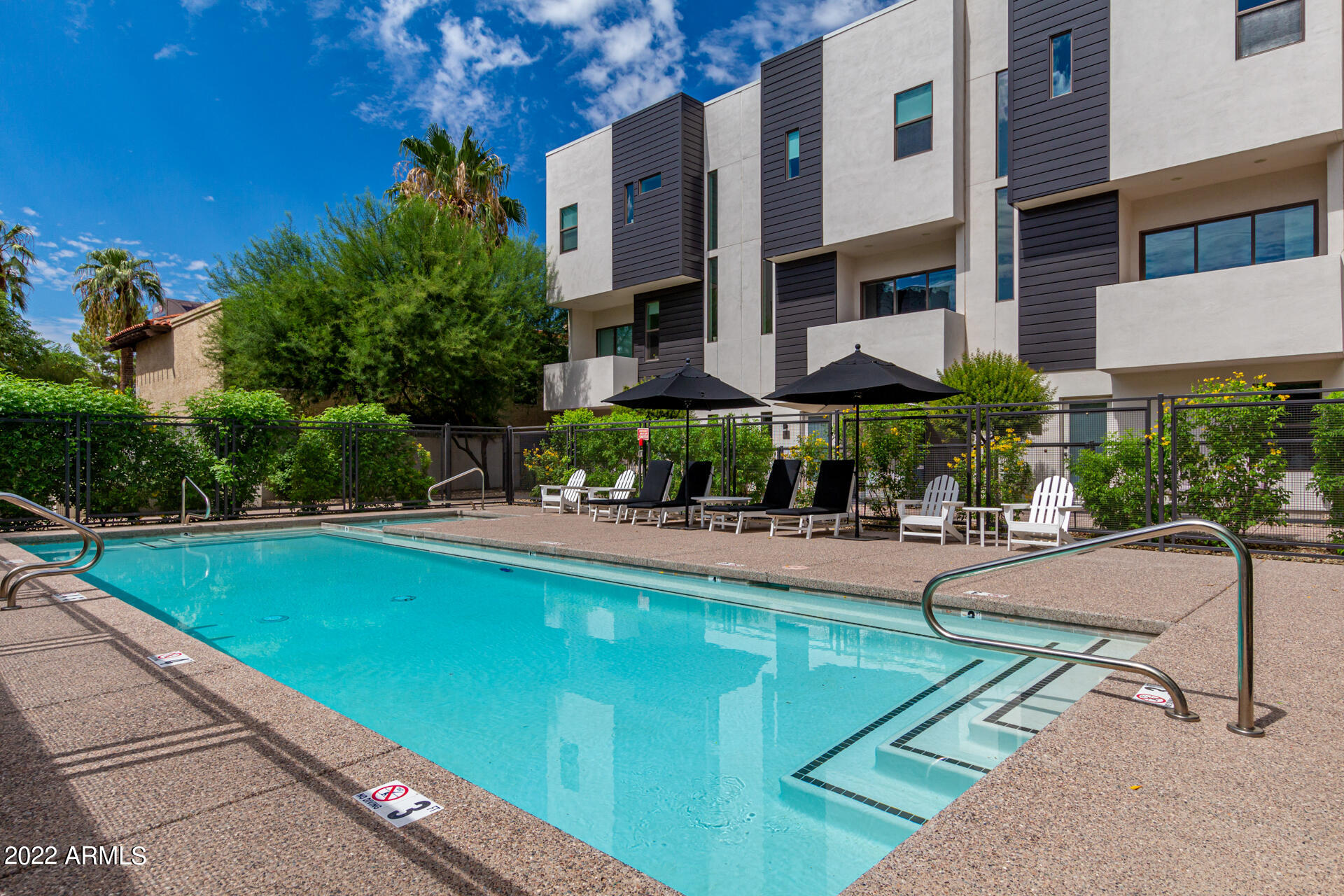 325 East Coronado Road, Unit 16 Phoenix, AZ 85004 - Photo 33 of 36 a view of swimming pool with outdoor seating and a garden