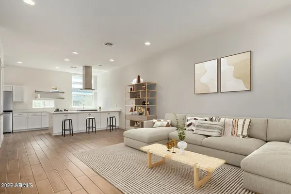 a living room with furniture and a wooden floor