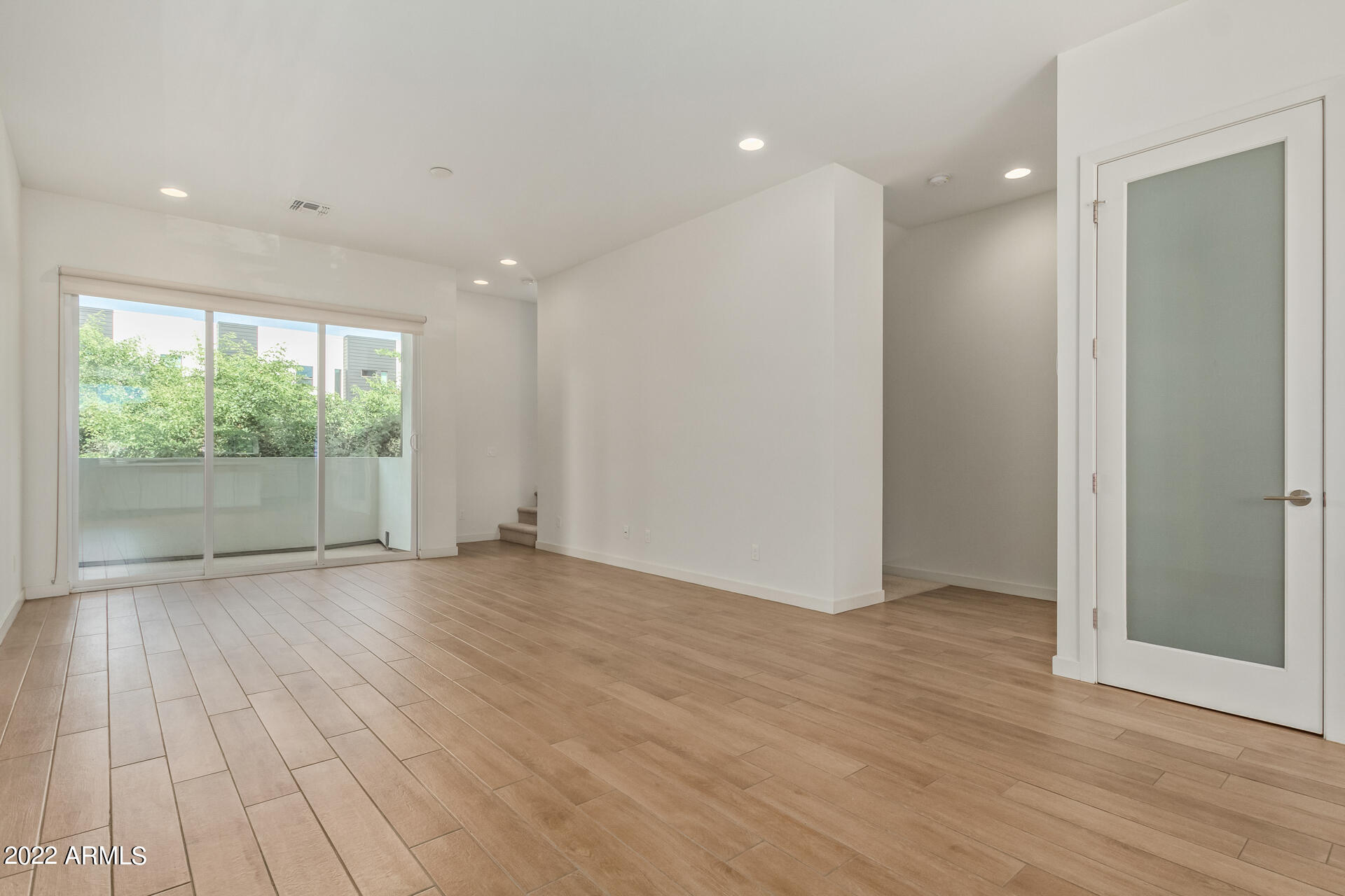 325 East Coronado Road, Unit 16 Phoenix, AZ 85004 - Photo 9 of 36 a view of an empty room with wooden floor and a window