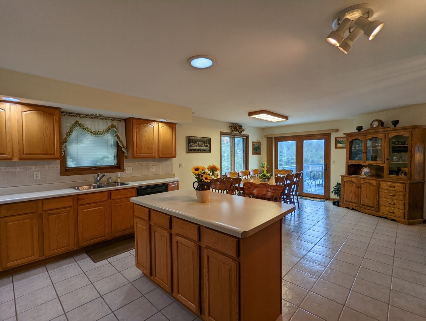 8597 East Winneshiek Road Ridott, IL 61067 - Photo 16 of 49 a large kitchen with kitchen island a sink a counter space and stainless steel appliances