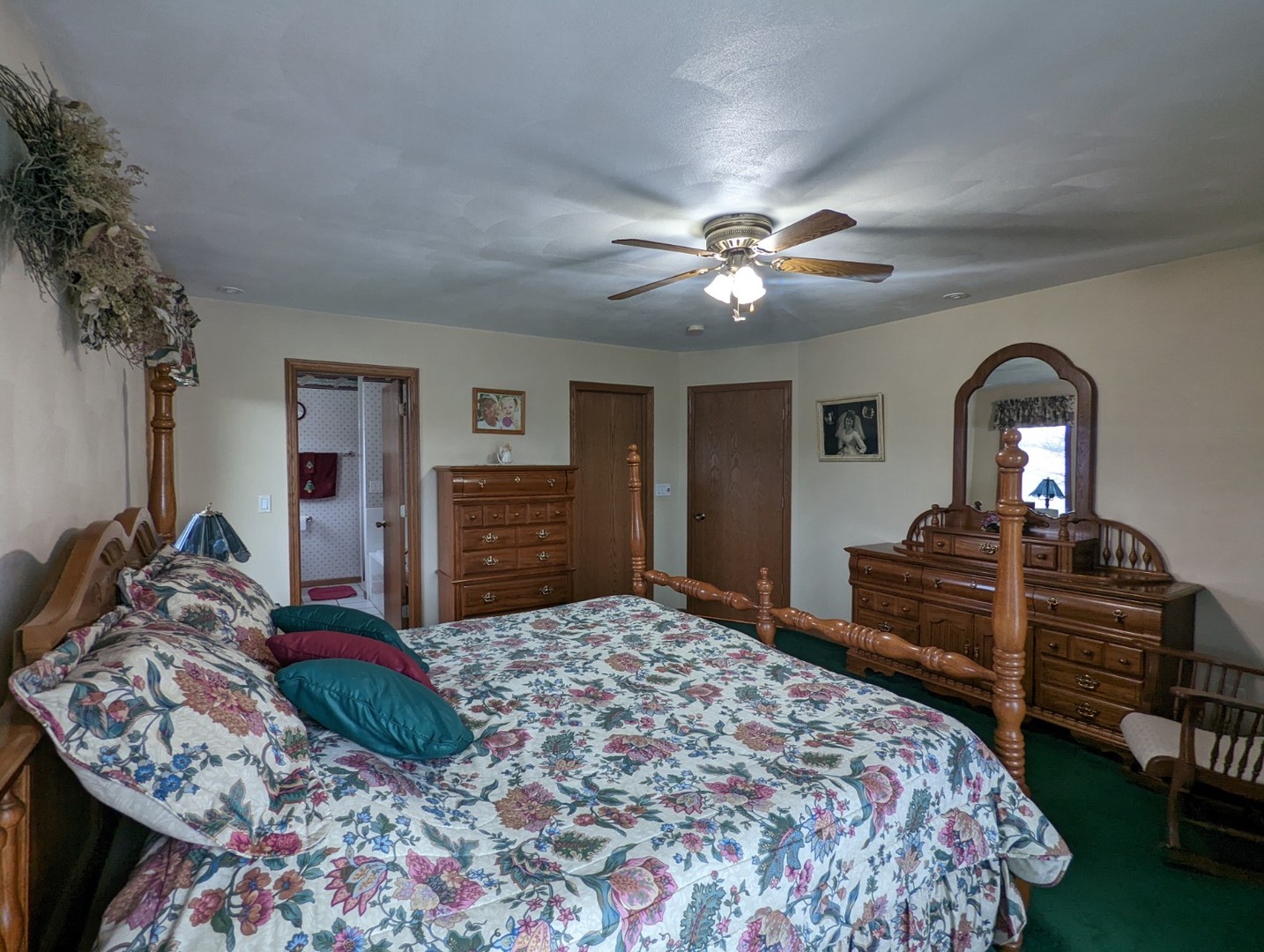 8597 East Winneshiek Road Ridott, IL 61067 - Photo 20 of 49 a bedroom with a bed and dresser with mirror