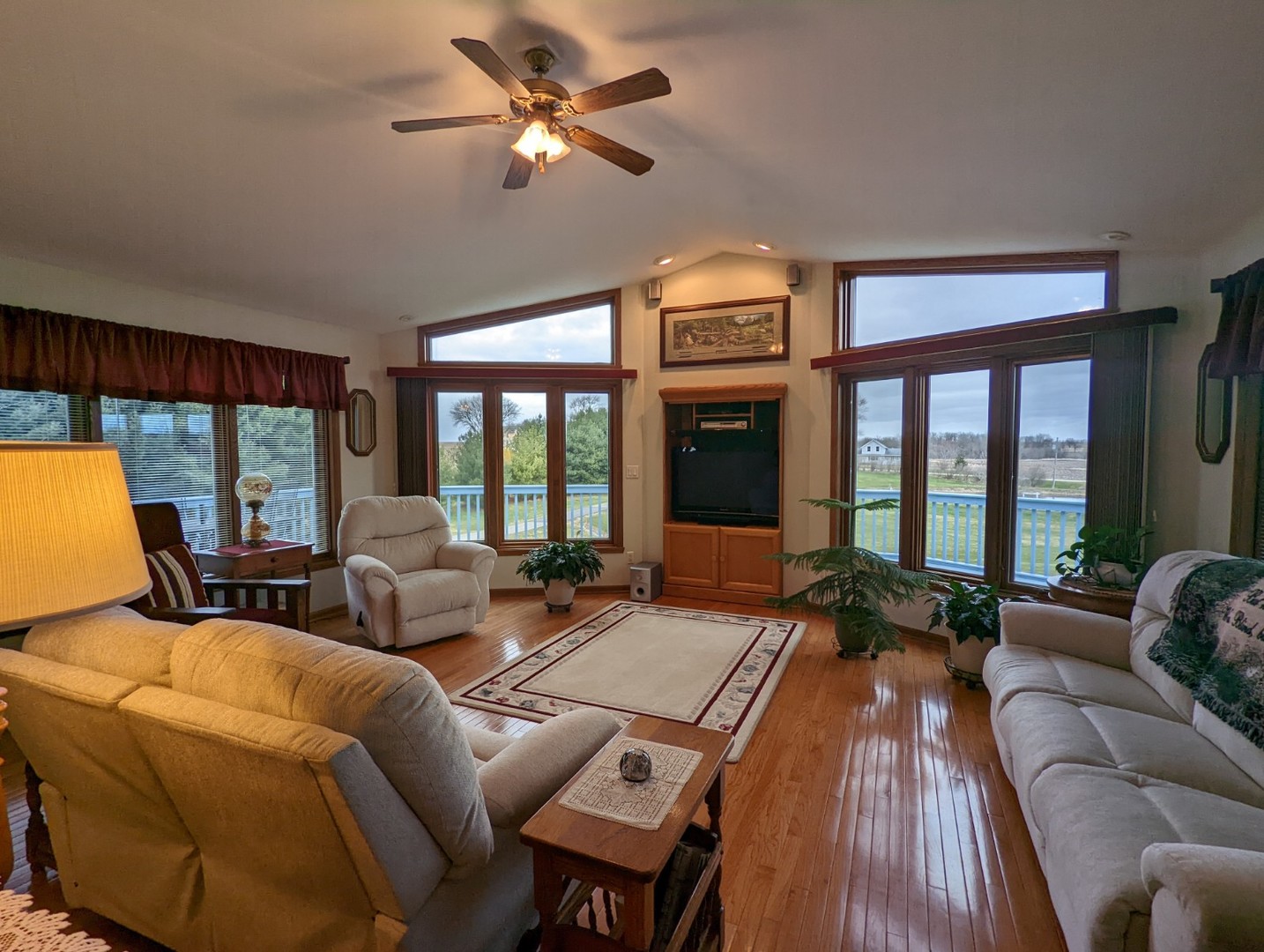 8597 East Winneshiek Road Ridott, IL 61067 - Photo 33 of 49 a living room with furniture two large windows and a flat screen tv