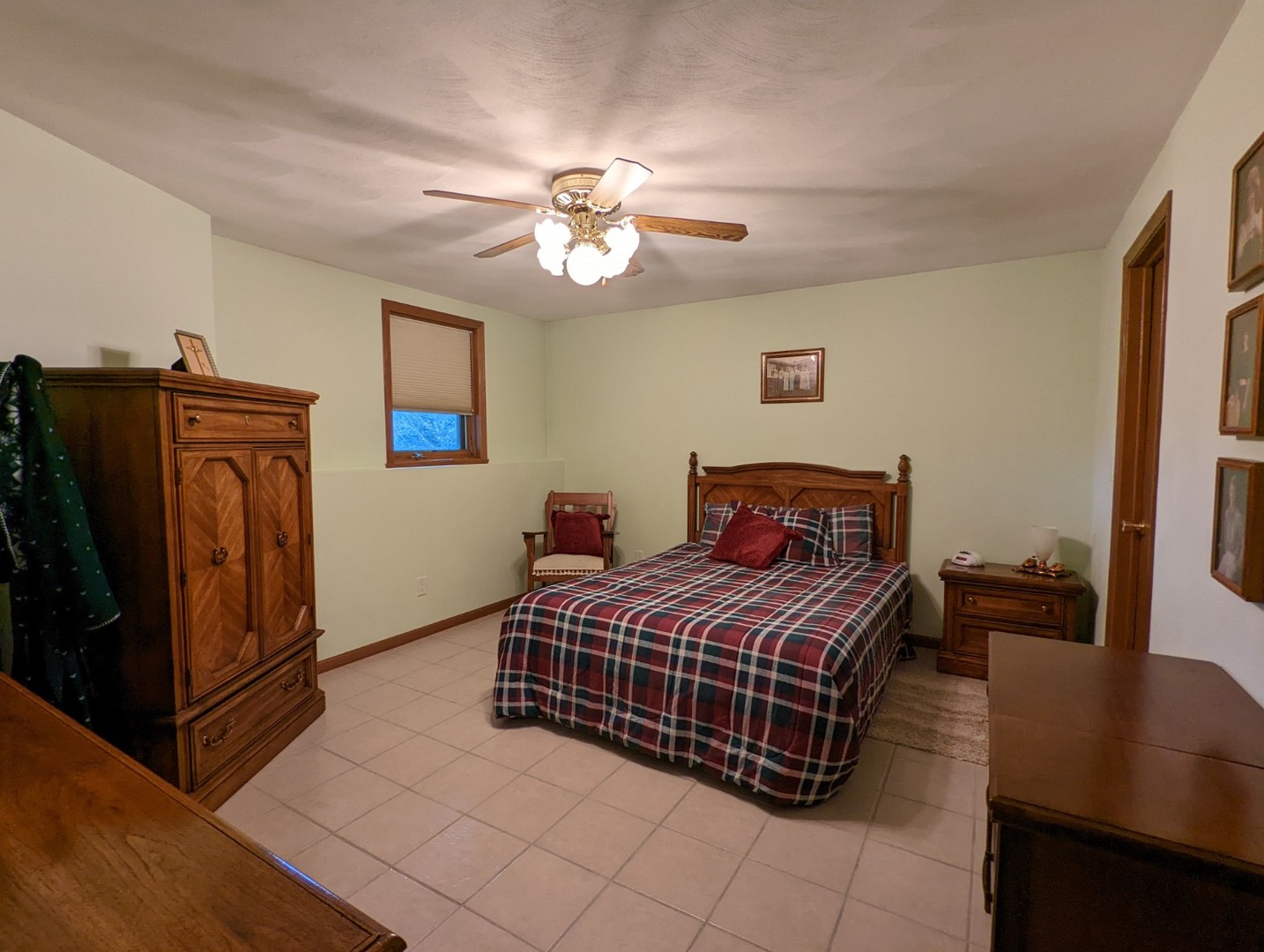 8597 East Winneshiek Road Ridott, IL 61067 - Photo 34 of 49 a bedroom with a bed and a chandelier