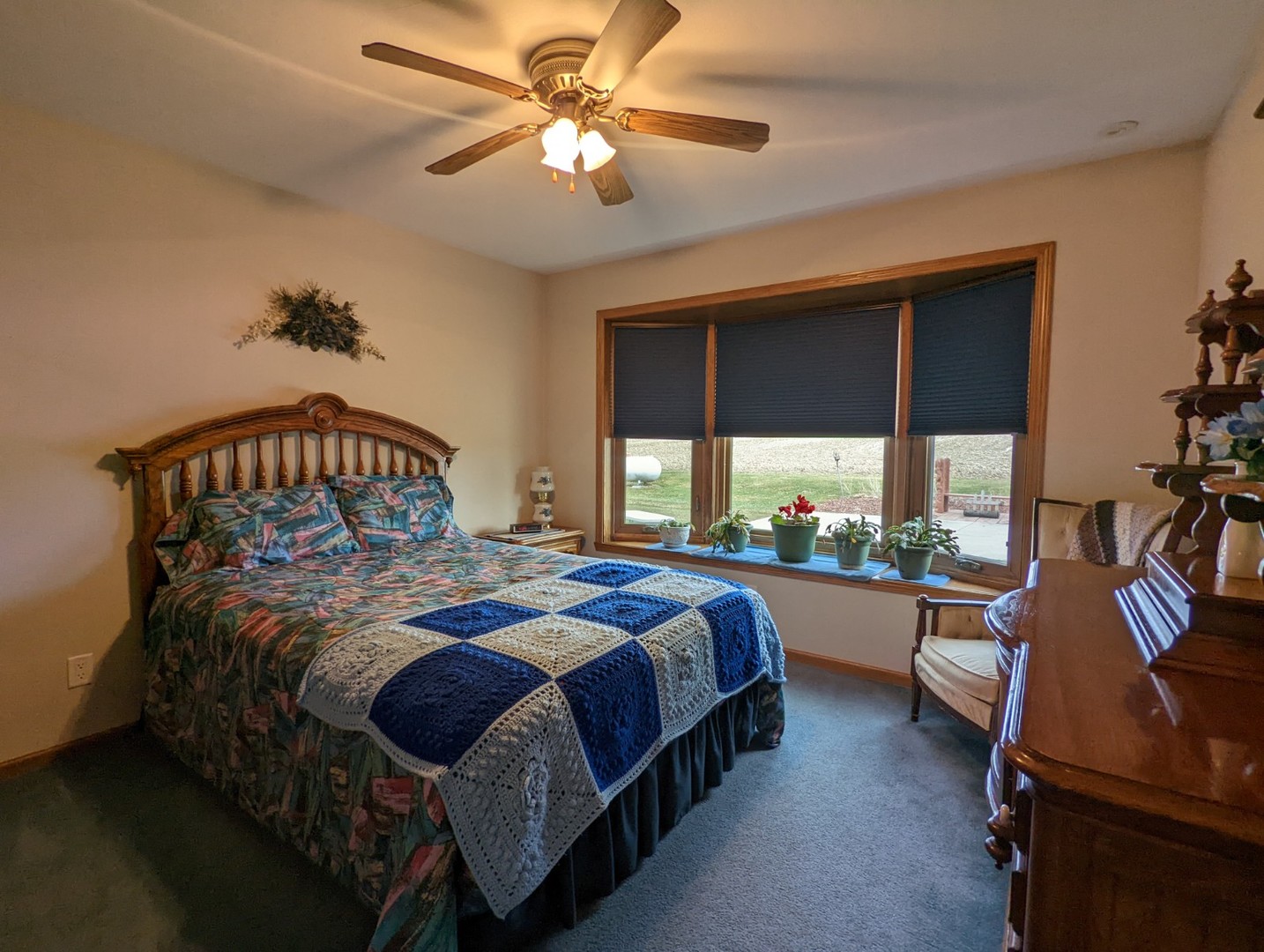 8597 East Winneshiek Road Ridott, IL 61067 - Photo 40 of 49 a bedroom with a bed a large window and walk in closet