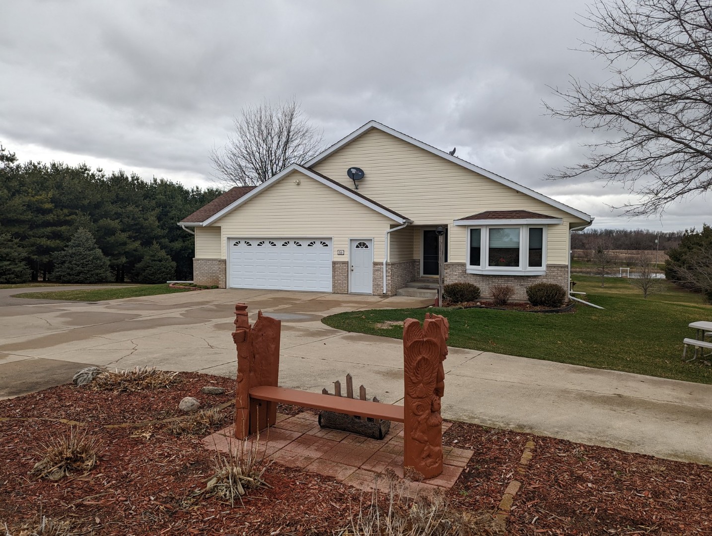 8597 East Winneshiek Road Ridott, IL 61067 - Photo 9 of 49 a front view of a house with a yard and garage