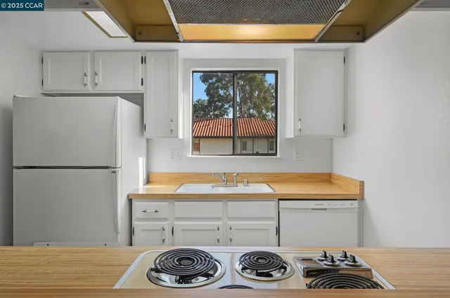 a kitchen with a refrigerator and a stove