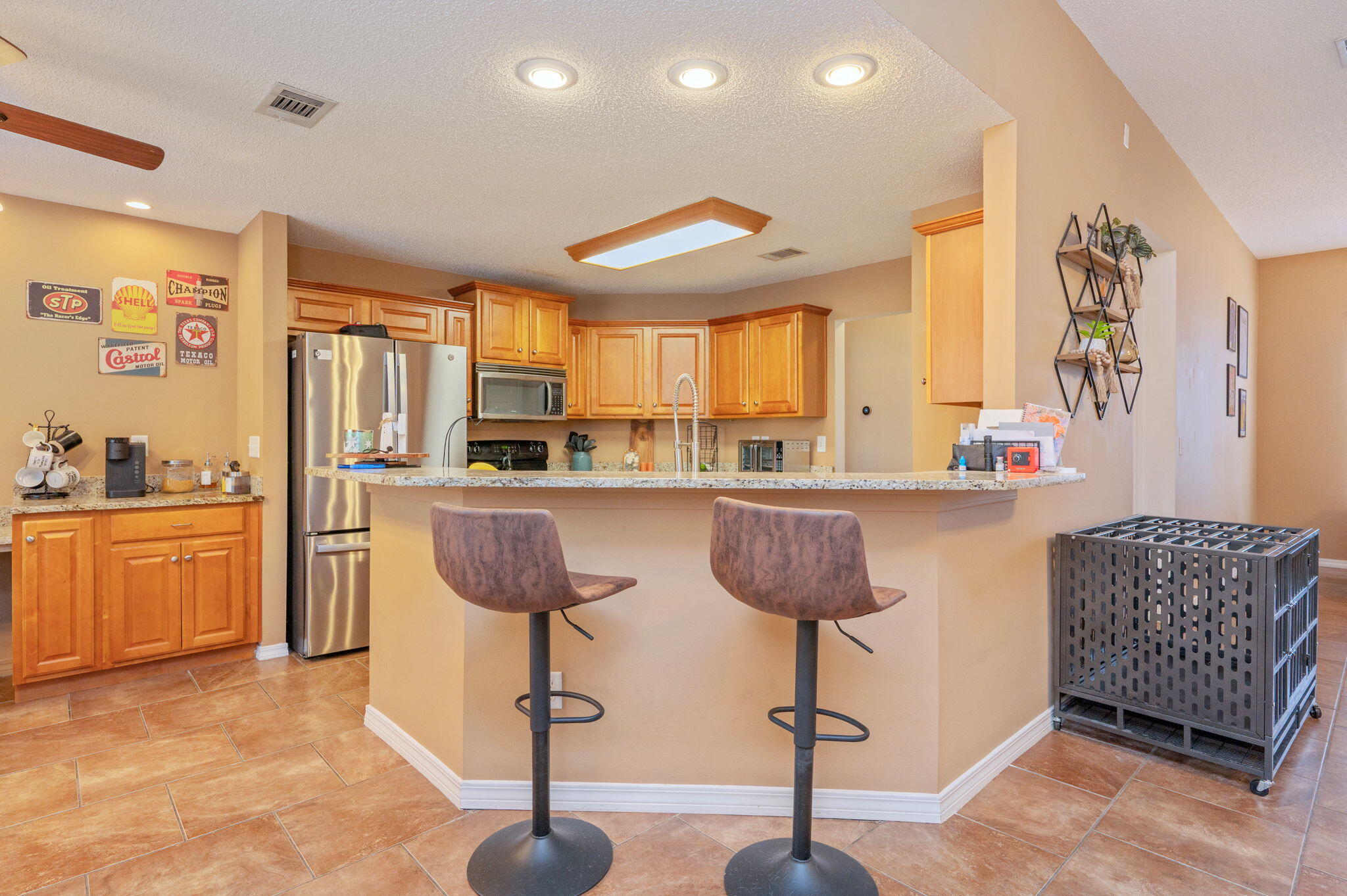 109 Tranquility Drive Crestview, FL 32536 - Photo 12 of 41 a kitchen with stainless steel appliances kitchen island granite countertop a refrigerator a sink dishwasher a dining table and chairs with wooden floor