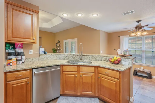 a kitchen with stainless steel appliances granite countertop a sink and cabinets
